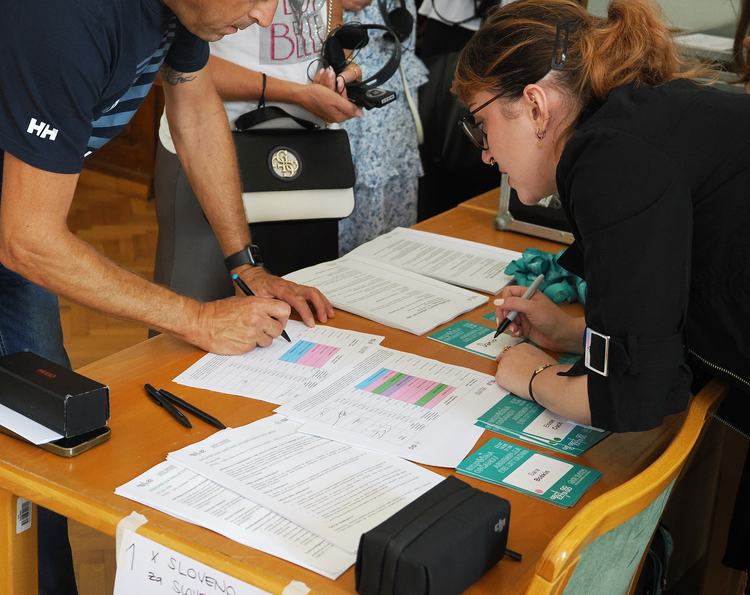 A participant signs in before the Assembly
