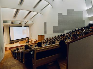 A group of students in a lecture hall. Photo credits: Dom Fou